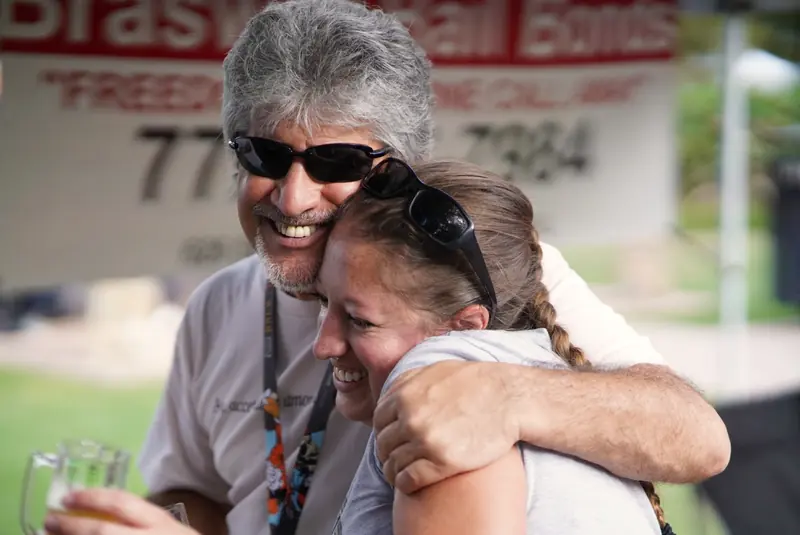 Two friends in a close embrace at the festival