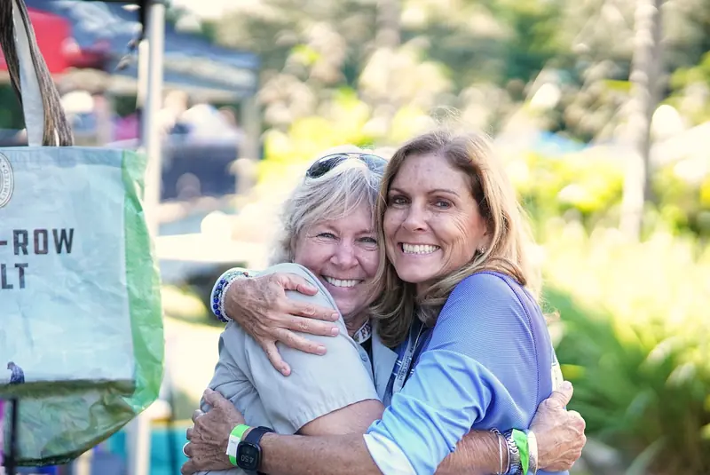 Two festivalgoers sharing an embrace at Treasure Coast Brew Fest